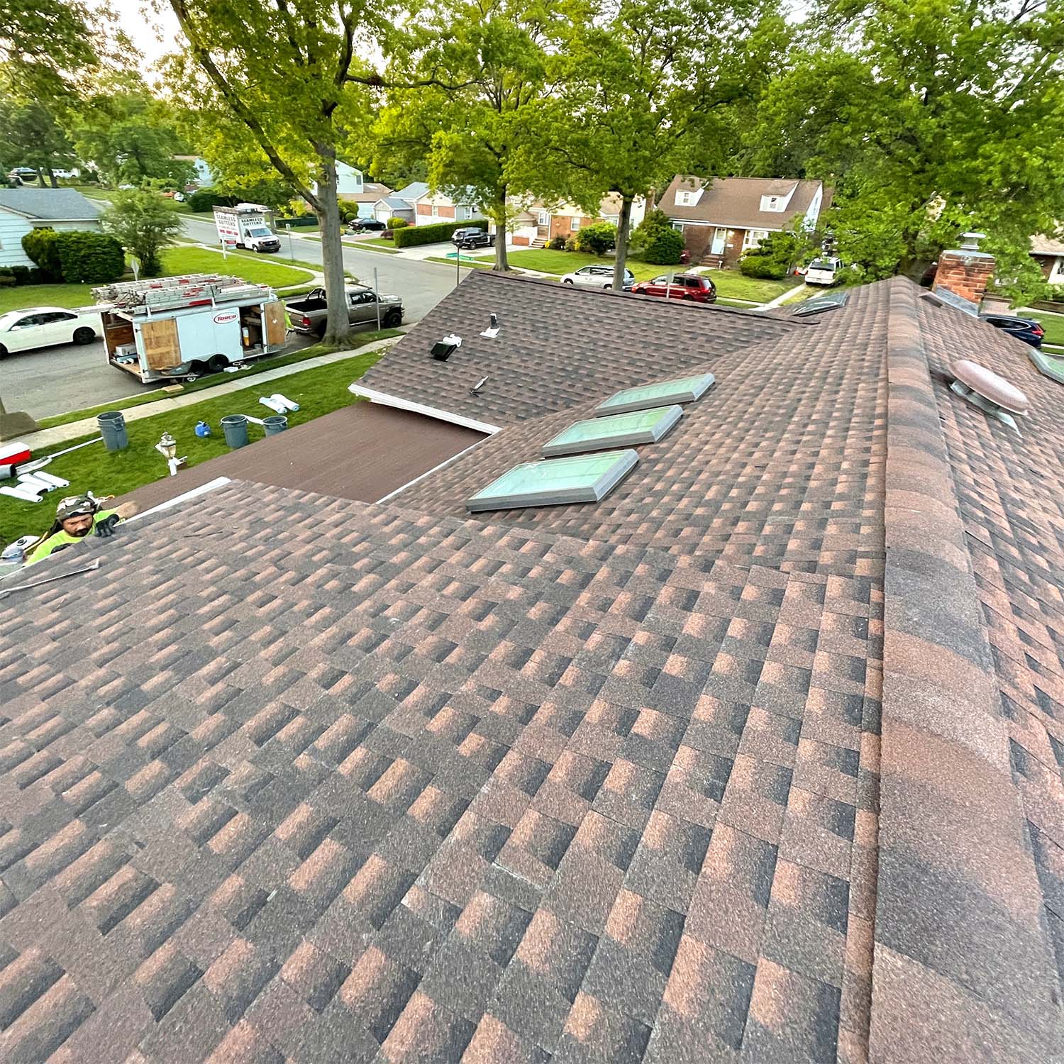 Three new skylights on a freshly shingled brown roof