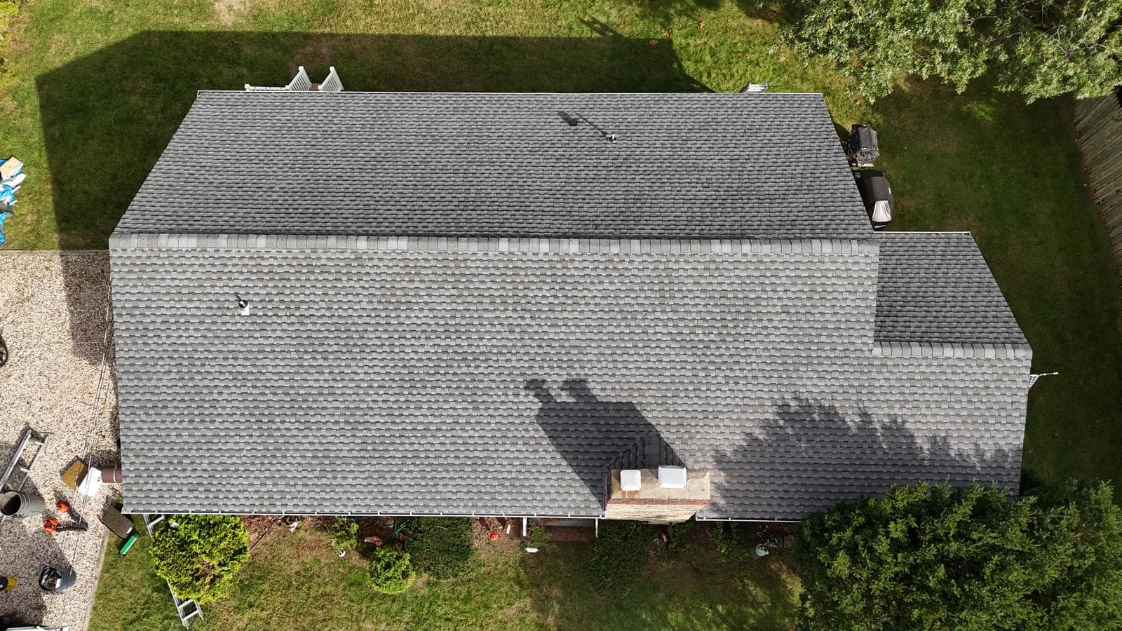 Top-down view of a finished gray shingle roof